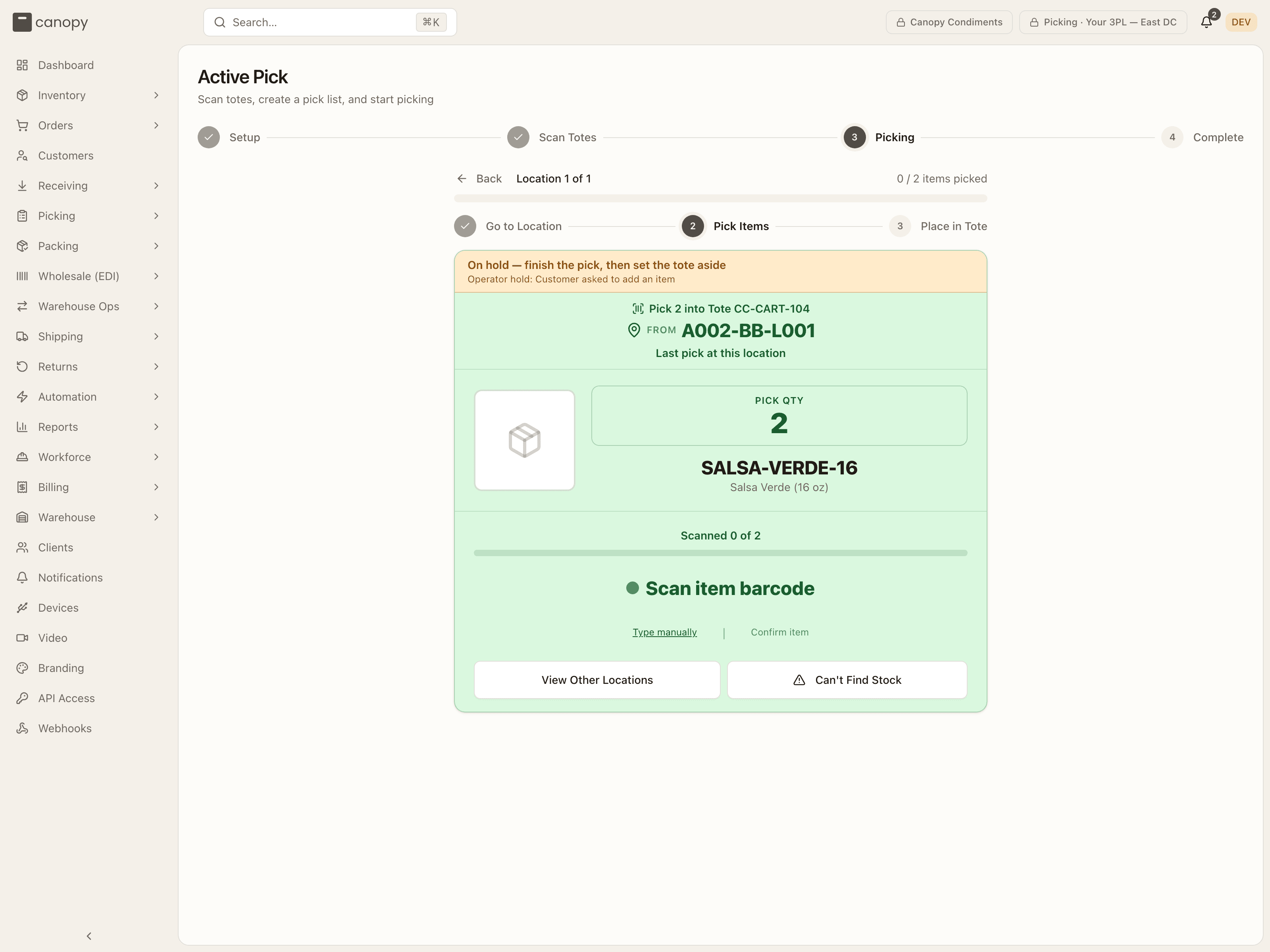 The pick card of a held order, with the On hold — finish the pick, then set the tote aside strip and the hold's reason